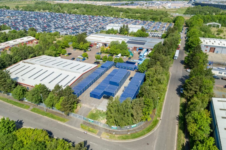 Aerial view of Optima Self Store Corby showing blue storage containers and the surrounding industrial estate.