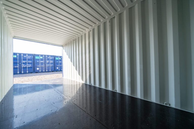 Interior of an empty self storage container at Optima Self Store Corby with metal walls and an open entrance.